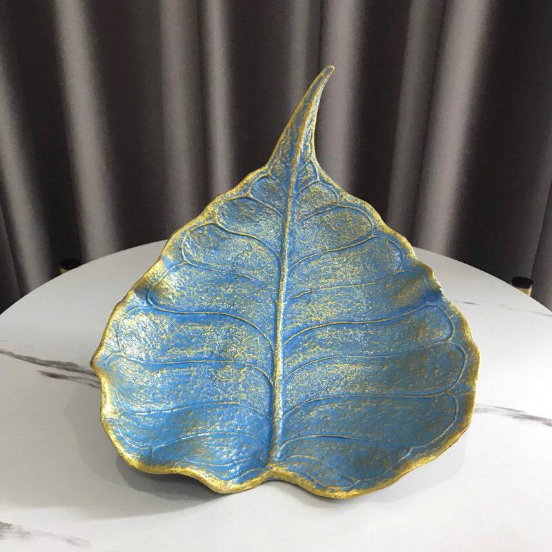 Blue and gold decorative leaf-shaped handmade wood powder bowl on white table