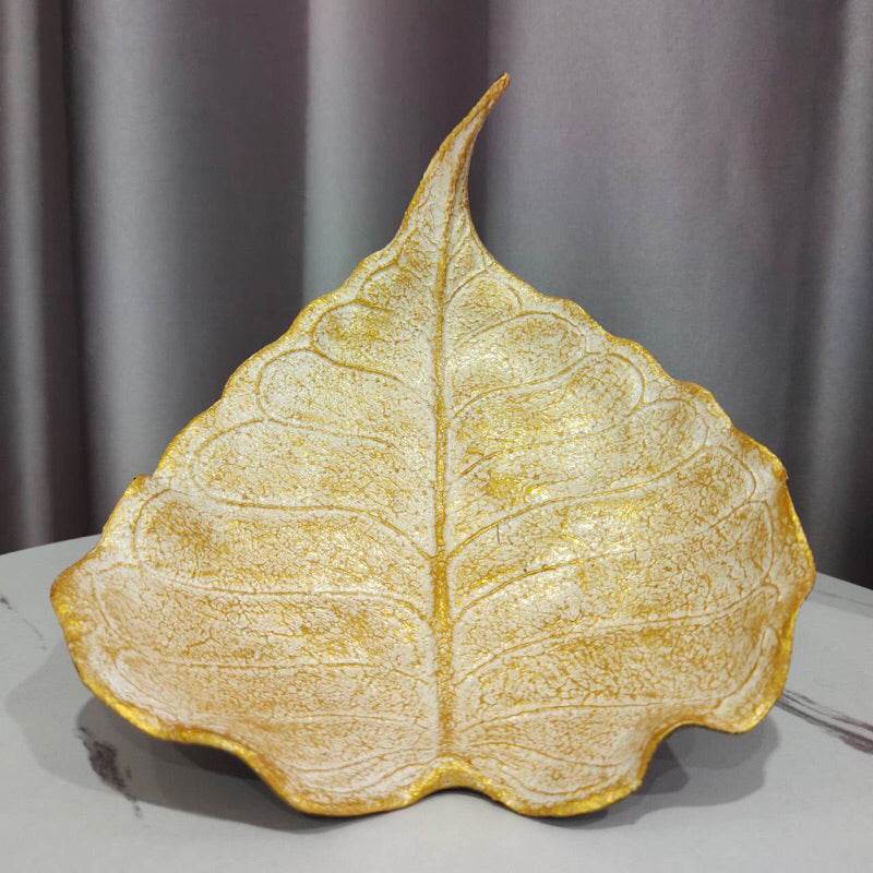 One-Sake.com handmade wood powder bowl shaped like a textured leaf with gold accents on a table