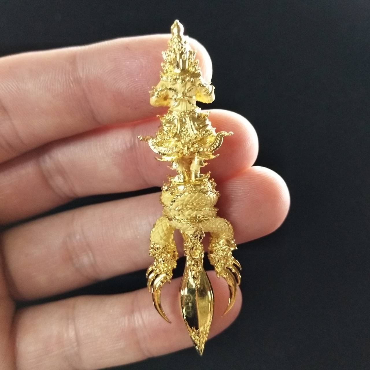 Intricate Vessuwan amulet for wealth held in hand, designed for home decoration and good fortune