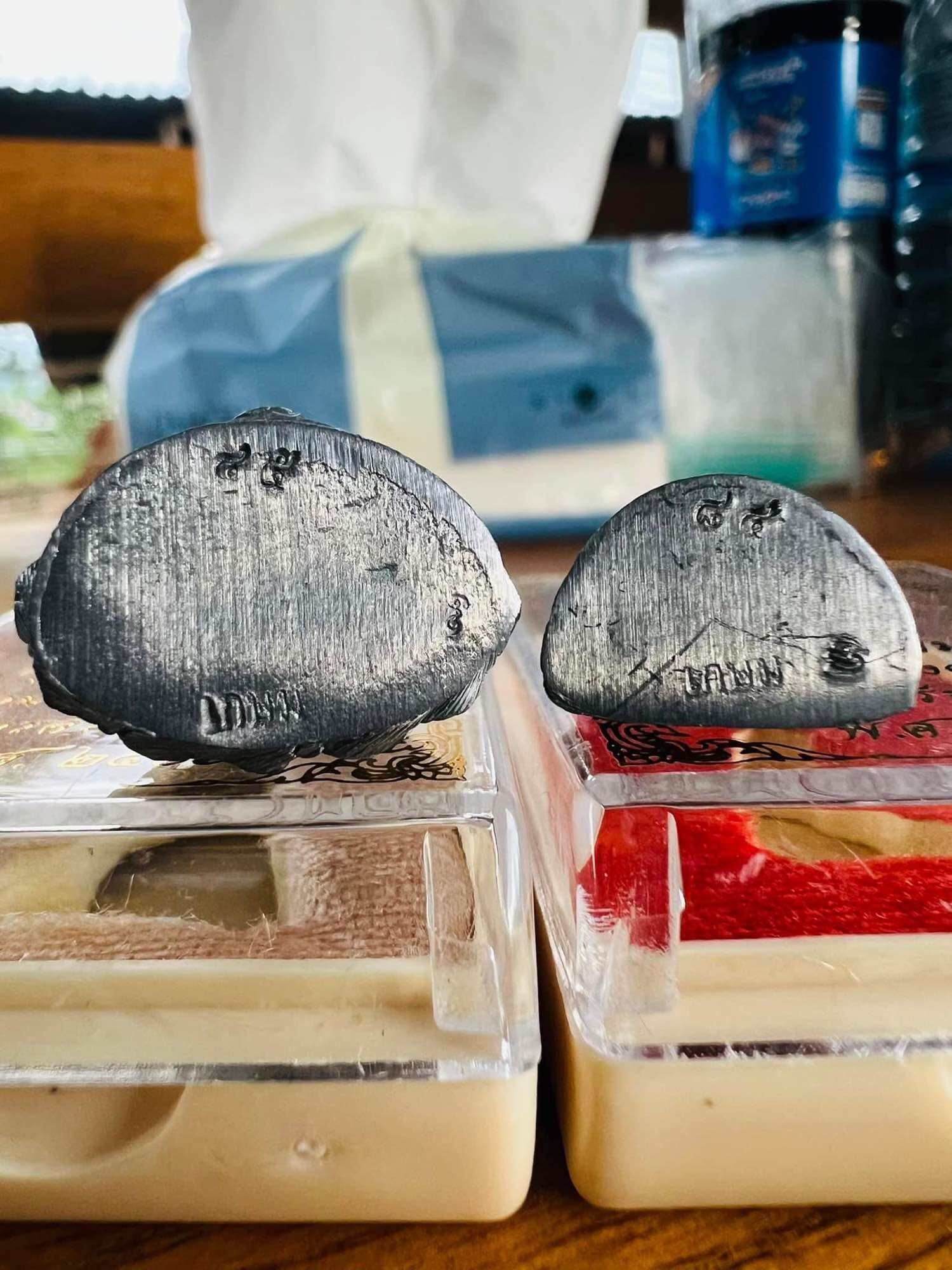 Mongkol Hemarat Kring spiritual charm two small silver amulet bases on display boxes Thai Blessing Co