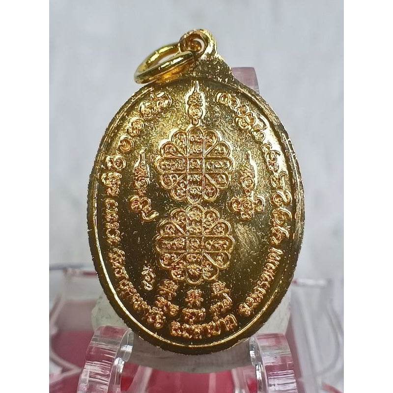 Wat That Mahachai authentic amulet gold oval pendant with intricate Thai script and symbols