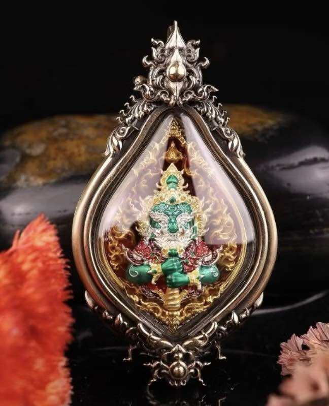 Wessuwan protection coin encased in ornate silver frame with colorful deity design for spiritual protection