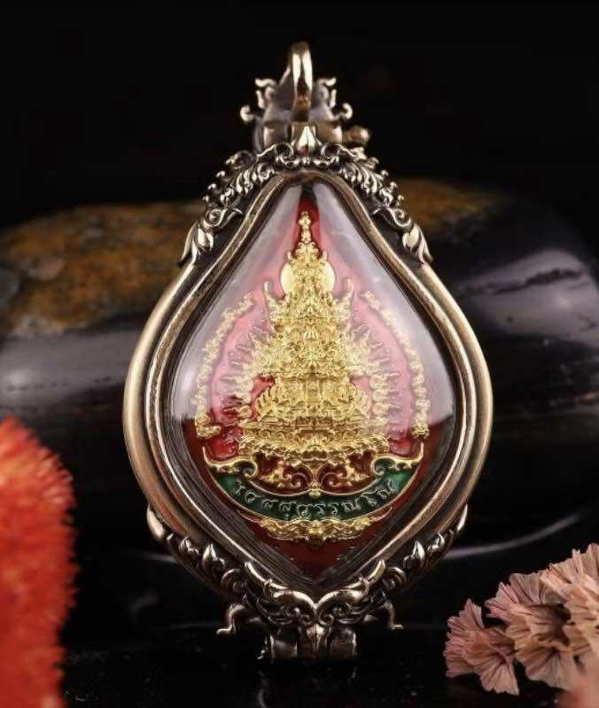 Wessuwan protection coin in an ornate silver pendant with intricate details and vibrant colors