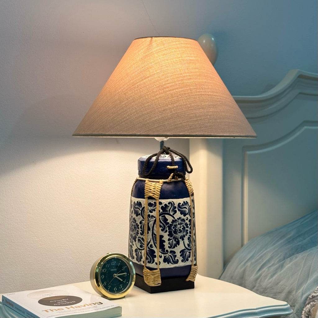 woven bamboo rice basket lamp with beige shade on nightstand beside bed and clock