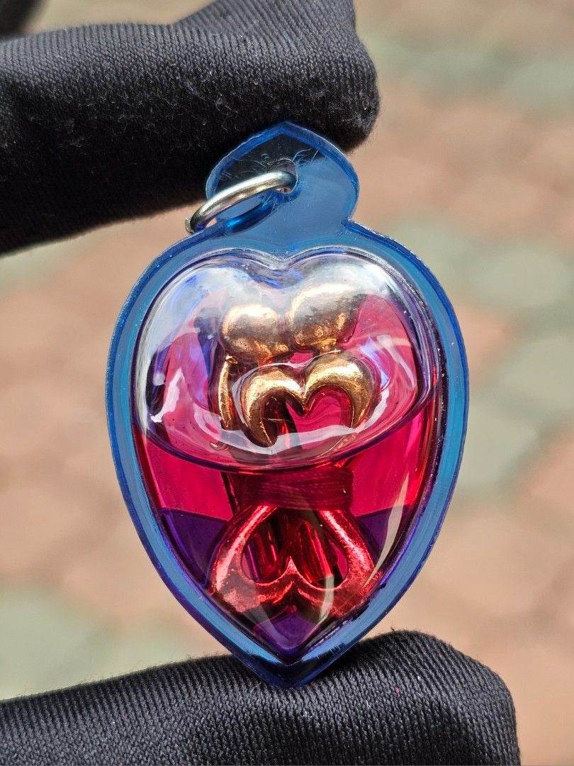 Yin Koo twin lovers amulet in a blue heart shape, designed for love and harmony in relationships