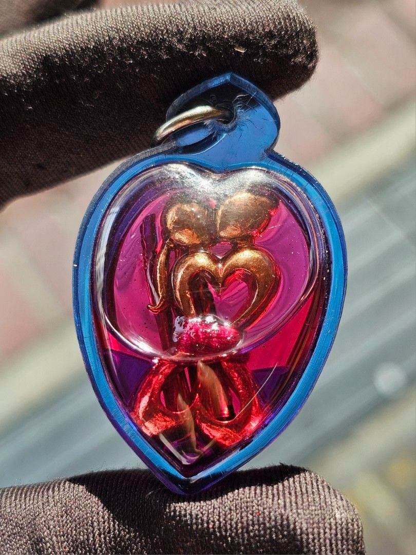 Yin Koo twin lovers amulet in a heart-shaped casing for love and harmony