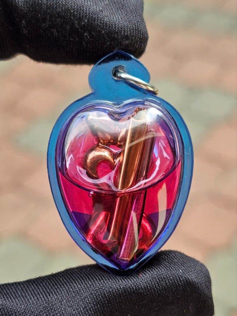 Yin Koo twin lovers amulet in a colorful heart-shaped casing for love and harmony