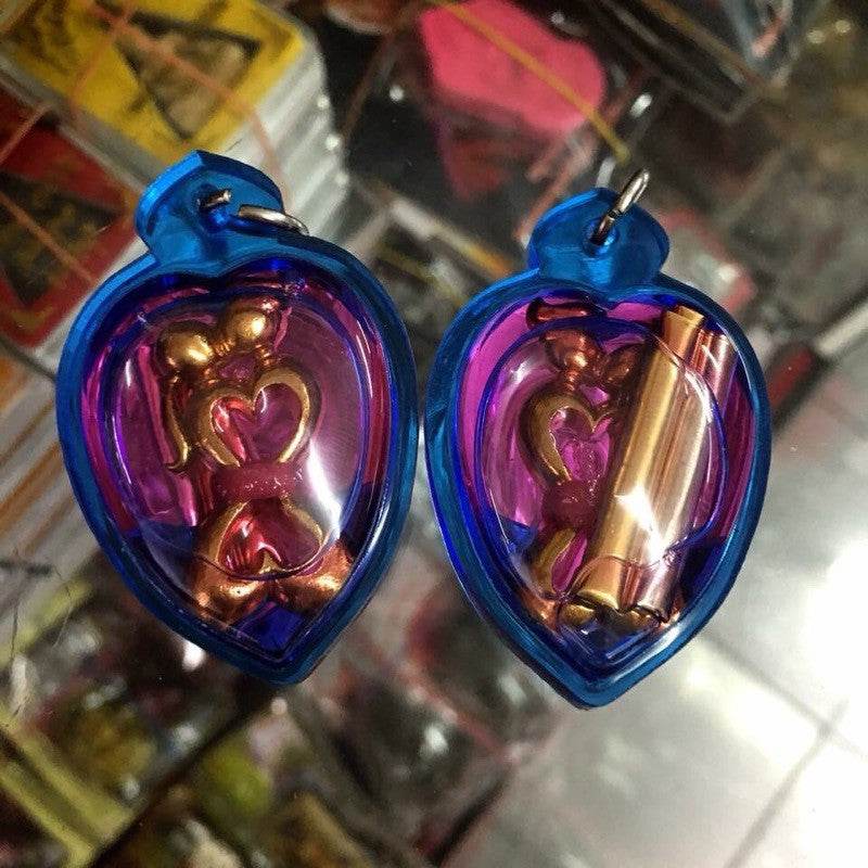 Yin Koo twin lovers amulet in vibrant blue and purple casing for love and relationship enhancement