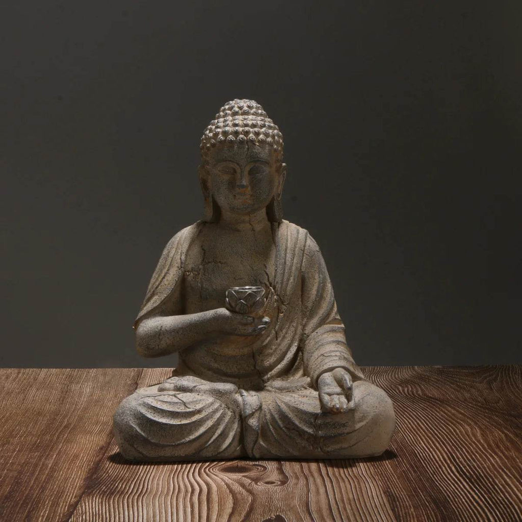 solar powered Buddha garden statue stone finish seated meditation pose holding lotus bowl on wooden table