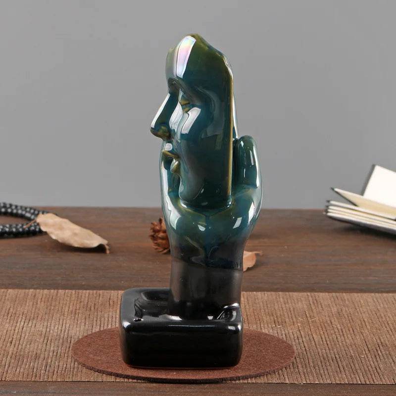 Green iridescent glazed ceramic sculptural backflow incense burner for home shaped as abstract face on black base
