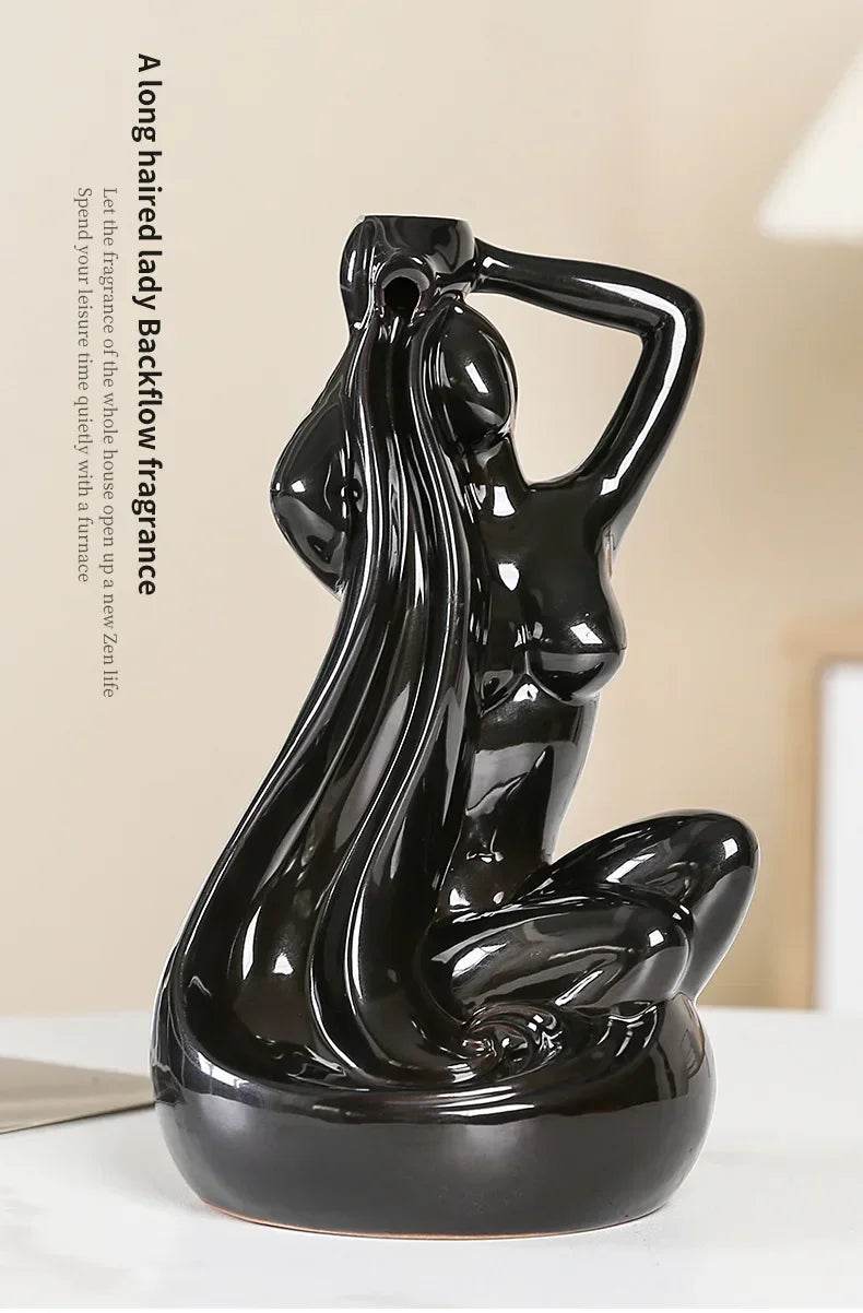 Glossy black ceramic backflow incense burner shaped as a seated long haired woman statue for home altar