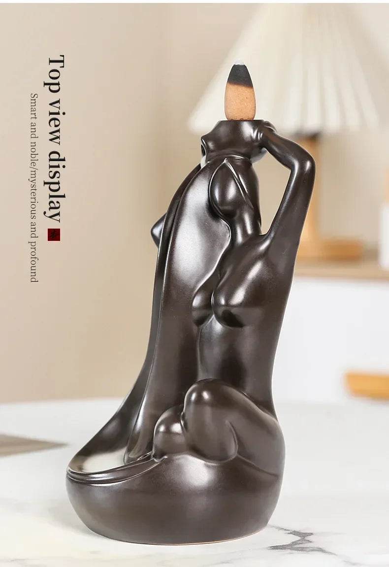 Thai Blessing Co dark brown ceramic backflow incense burner shaped like a reclining figure with cascading smoke waterfall